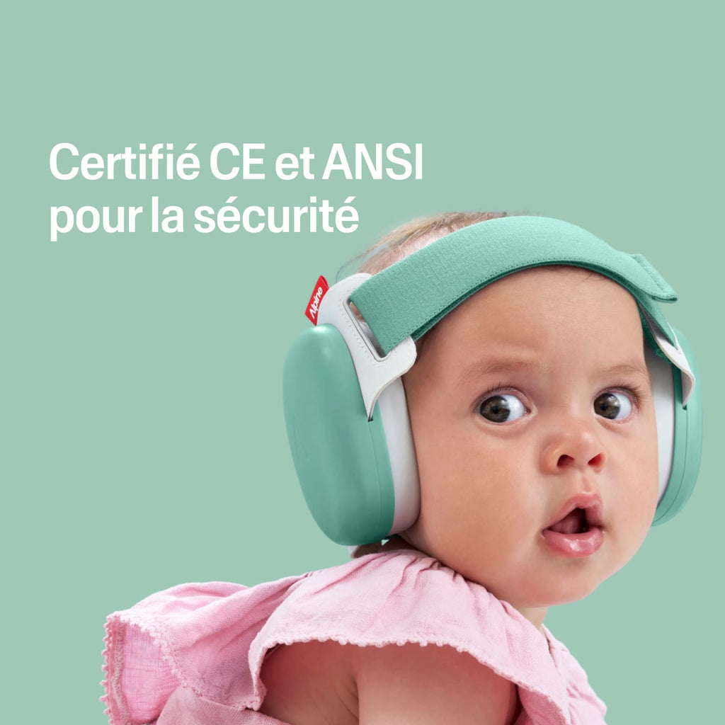 Baby wearing green ear protection with certification text on a light green background #lang_fr #color_sage-green